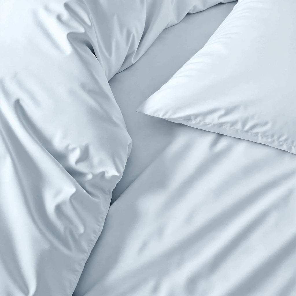 Australian sateen sheet set in light blue, close-up of wrinkled smooth fabric