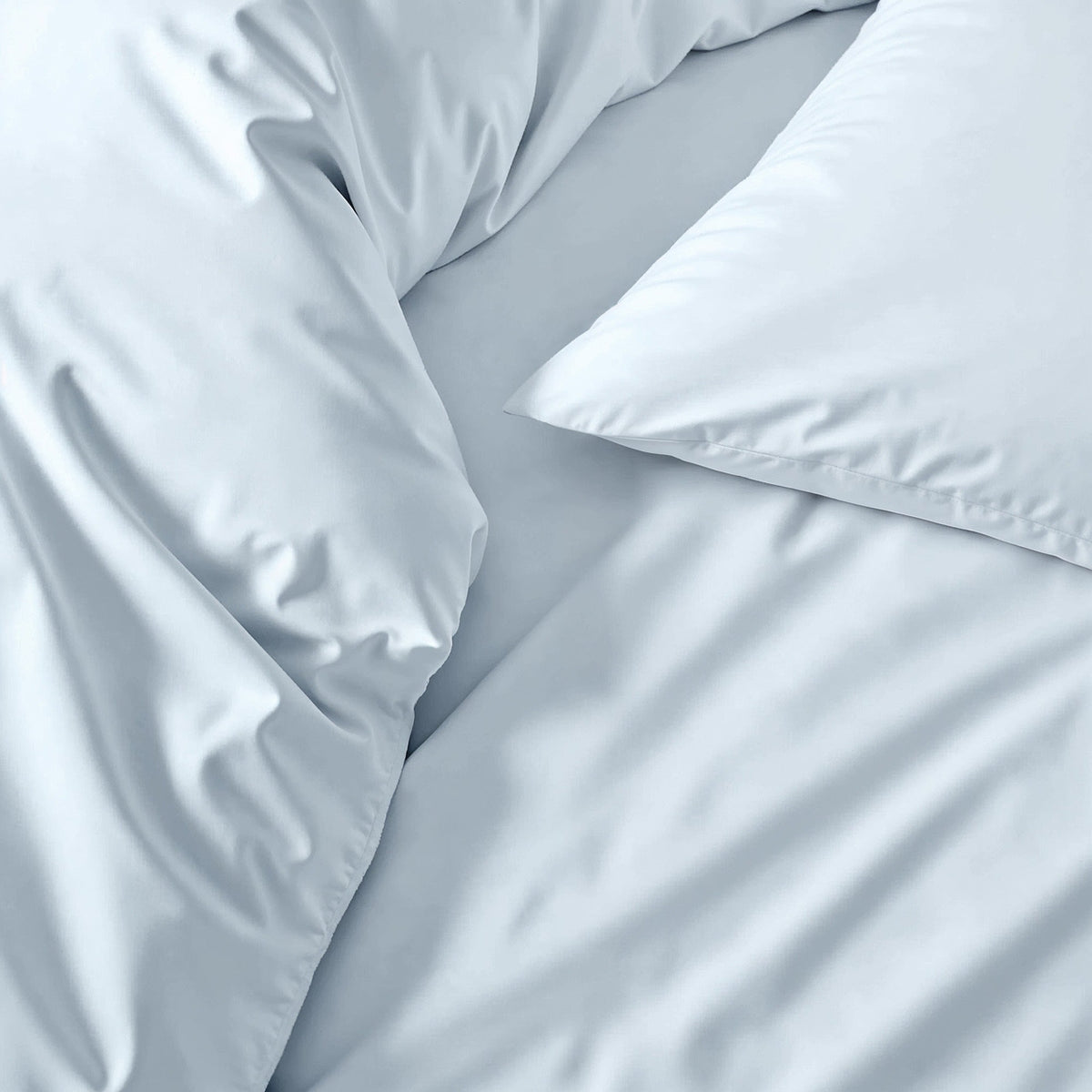 Australian sateen sheet set in light blue, close-up of wrinkled smooth fabric