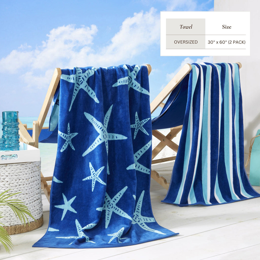 Blue cotton velour beach towel with fish print and striped edging, oversized folded on chair