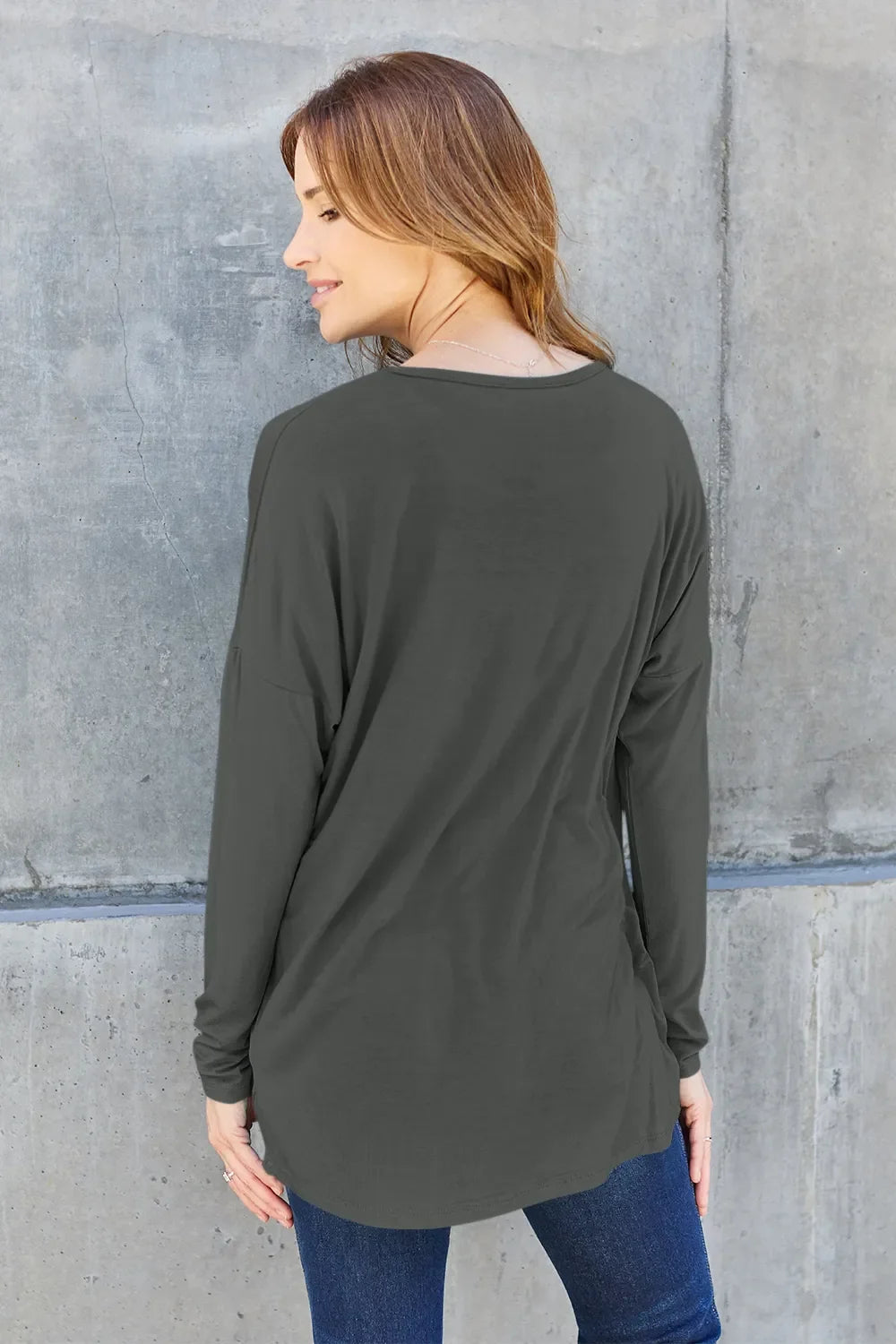 Dark gray long-sleeve relaxed tee, back view with curved hem