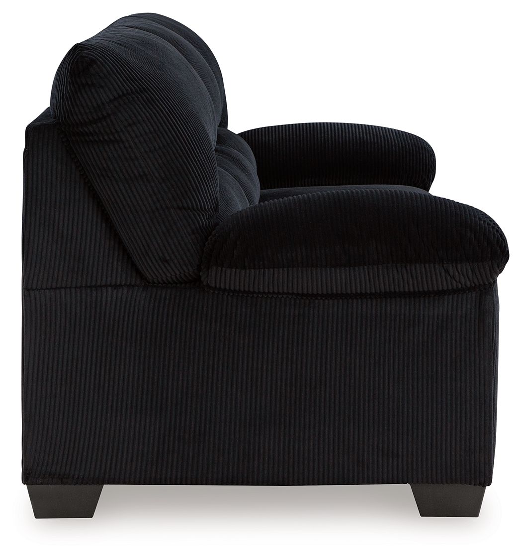 Black upholstered sofa loveseat with rolled arms and plush seat cushions