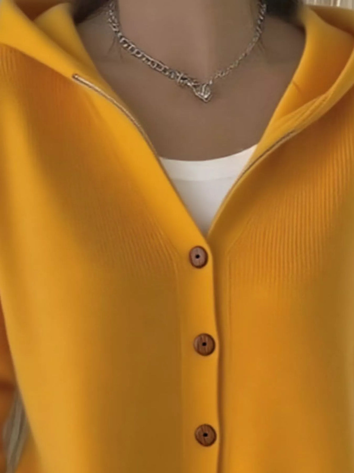 Mustard yellow hooded knit cardigan with collar, hood, and dark buttons