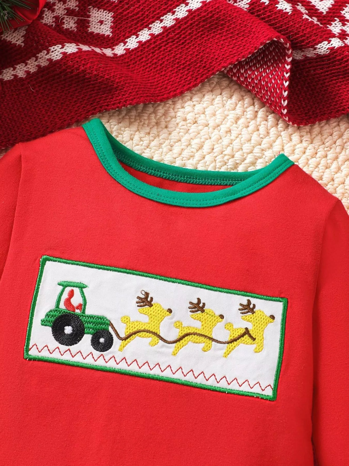 Red kids Christmas jumpsuit with embroidered tractor-and-reindeer panel and green trim