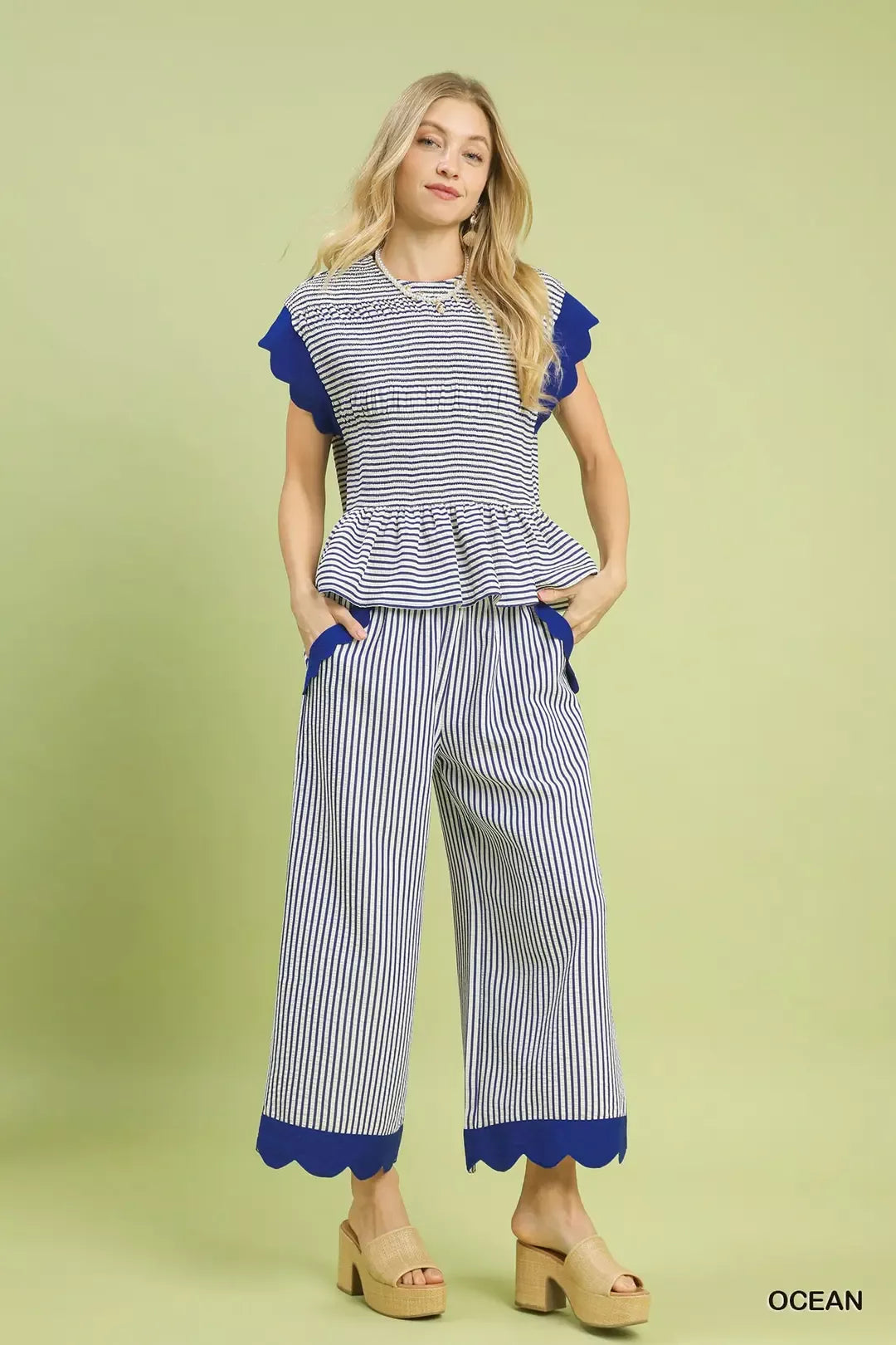 Navy-and-white striped peplum top with ruffle cap sleeves and gathered hem