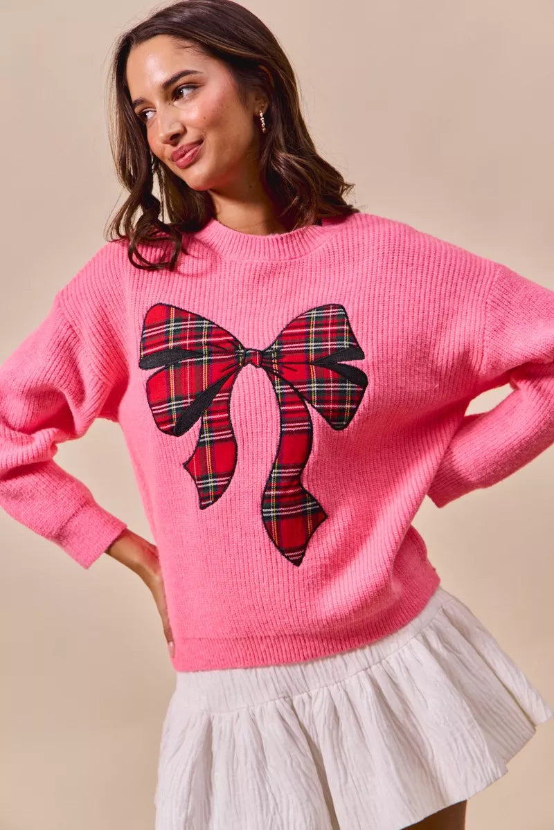 Pink crewneck sweater with plaid bow ribbon applique and long sleeves
