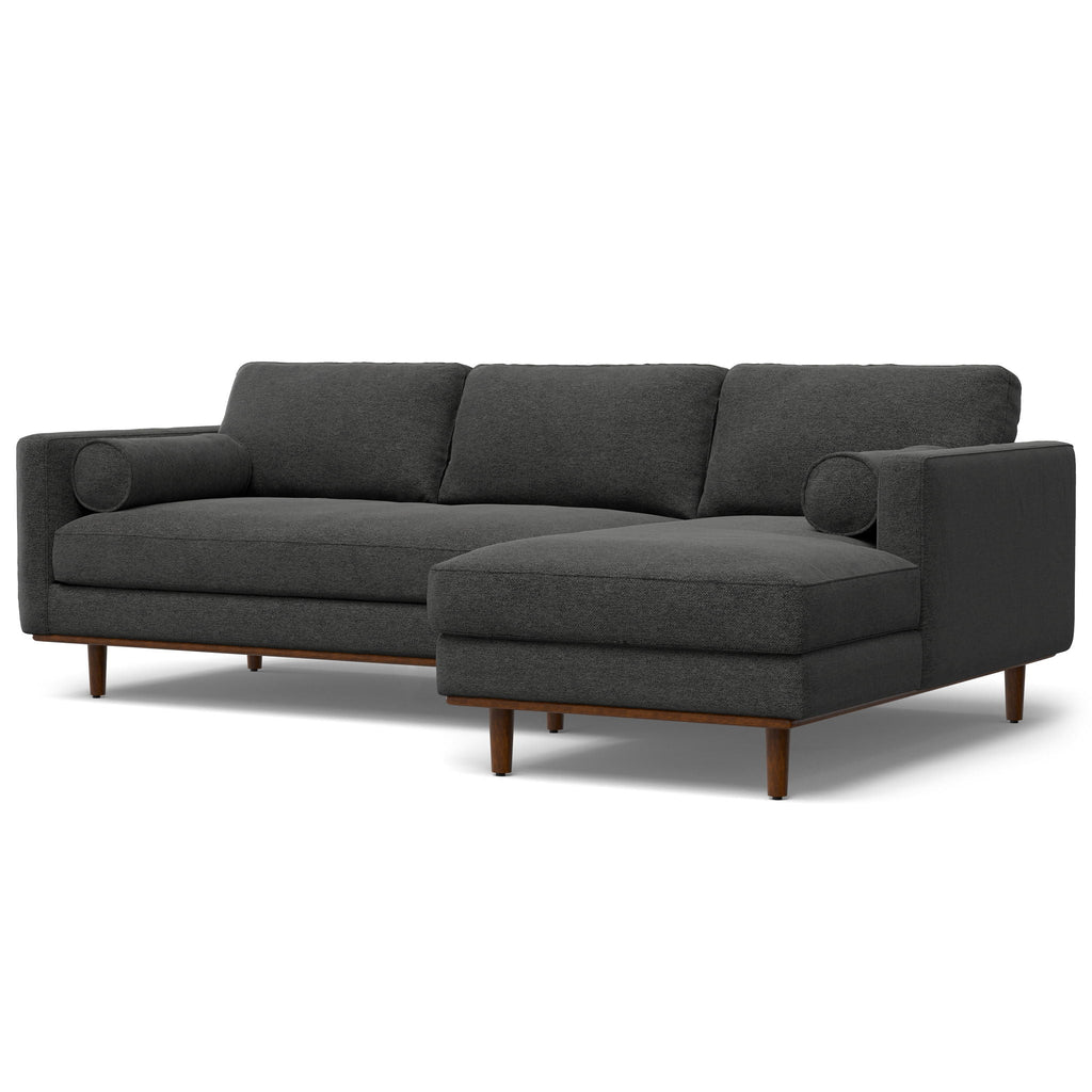 Dark gray upholstered sectional sofa with chaise and rounded arm details on legs