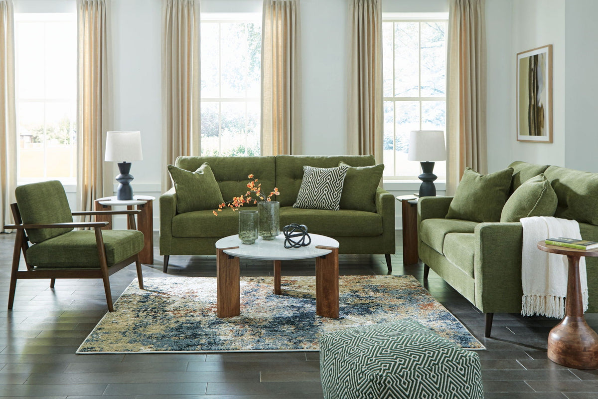 Green fabric sofa and loveseat set with tufted cushions and tapered legs