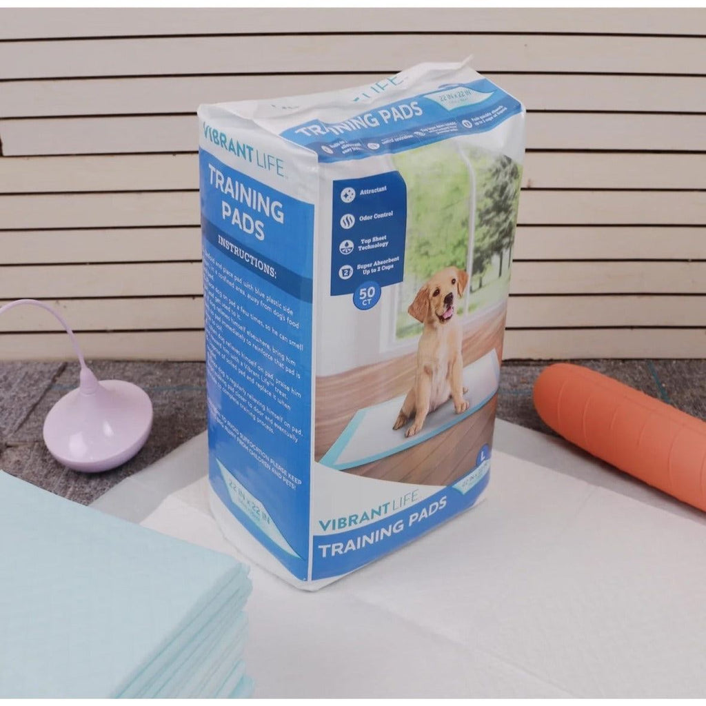Dog training pads pack with folded blue pad sheets on a light surface