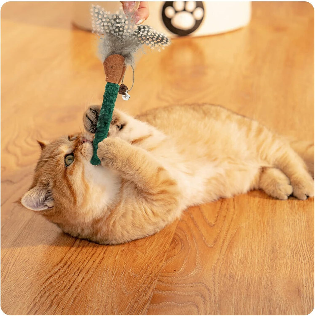 Cat chew stick toy with green textured wand and gray feather sprig held near cat