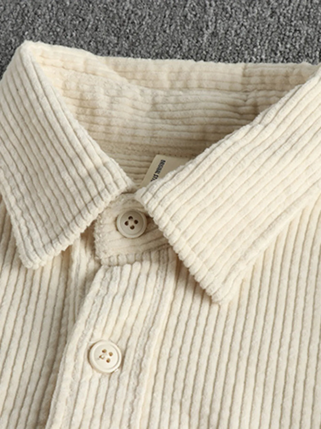 Light beige corduroy button-up shirt with pointed collar and two-button placket