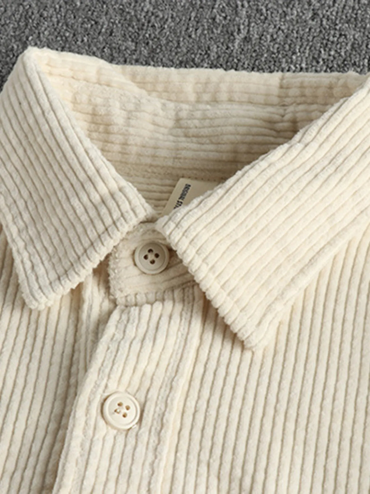 Light beige corduroy button-up shirt with pointed collar and two-button placket