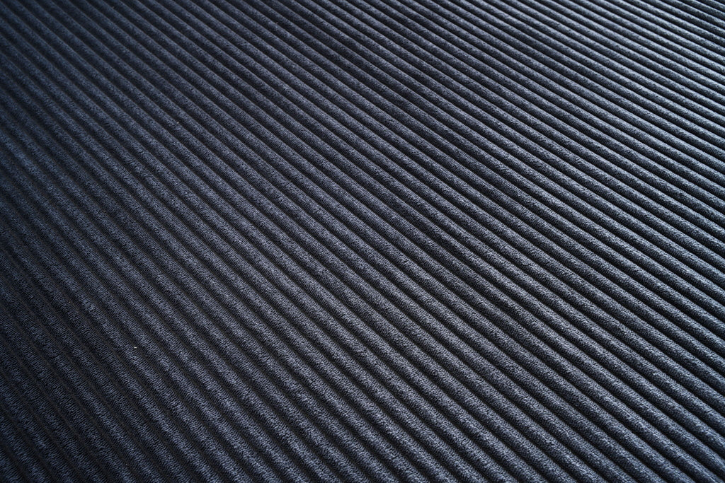L-shaped sectional sofa upholstery fabric swatch in dark blue, fine ribbed texture