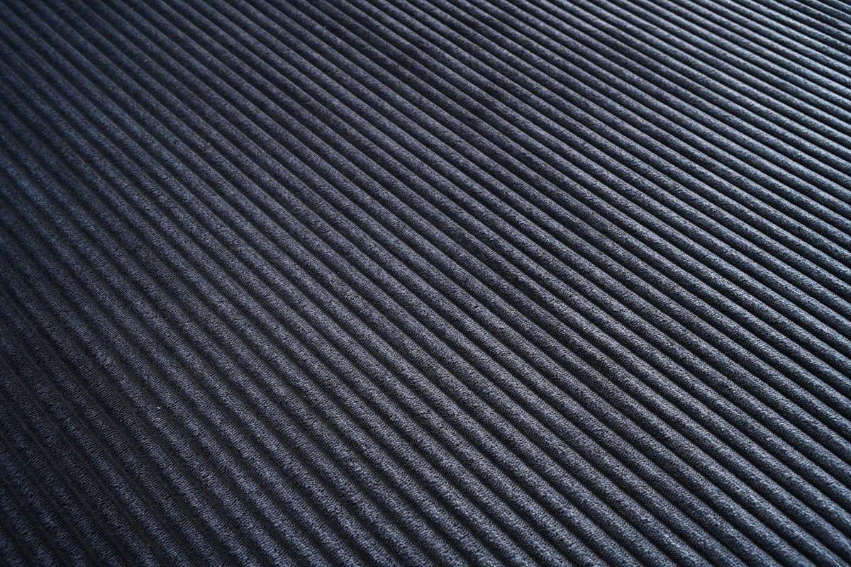 L-shaped sectional sofa upholstery fabric swatch in dark blue, fine ribbed texture