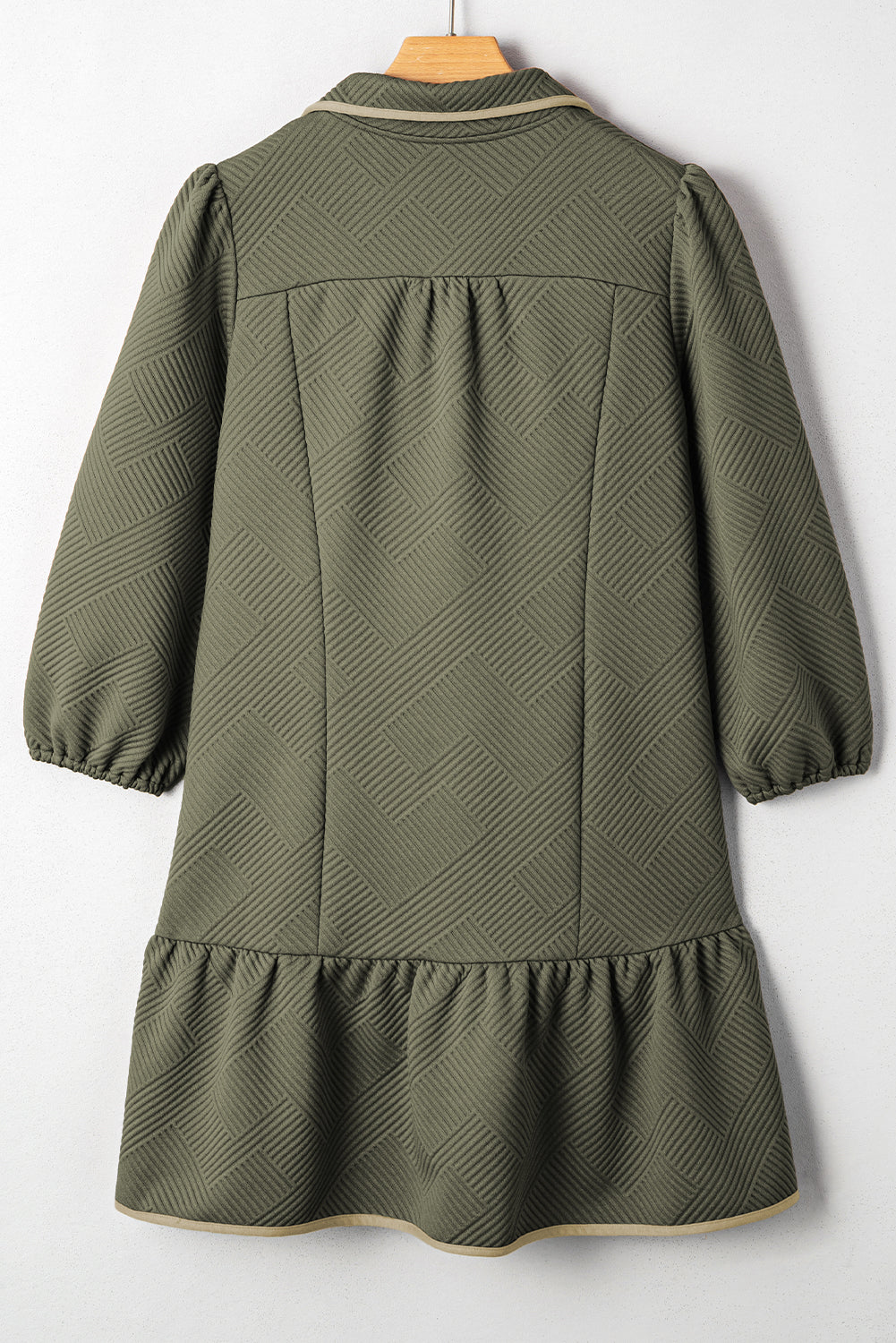 Back view of jungle green textured mini dress with quarter-zip yoke and tiered skirt