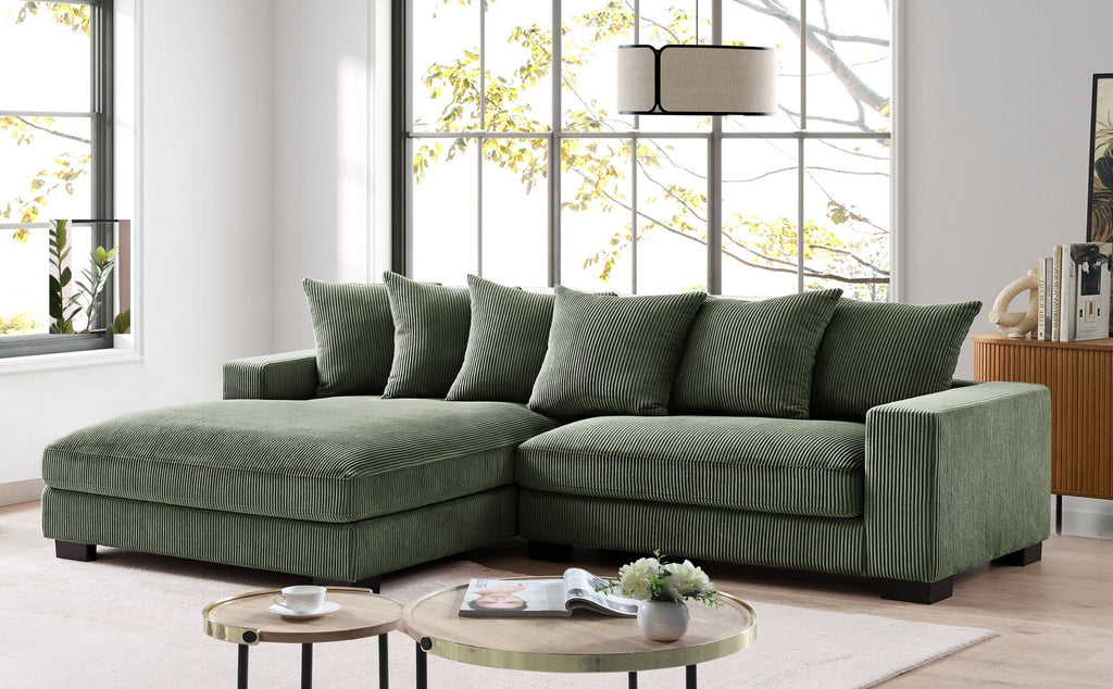 L-shaped sectional sofa with chaise in dark green, wide chaise section and back pillows