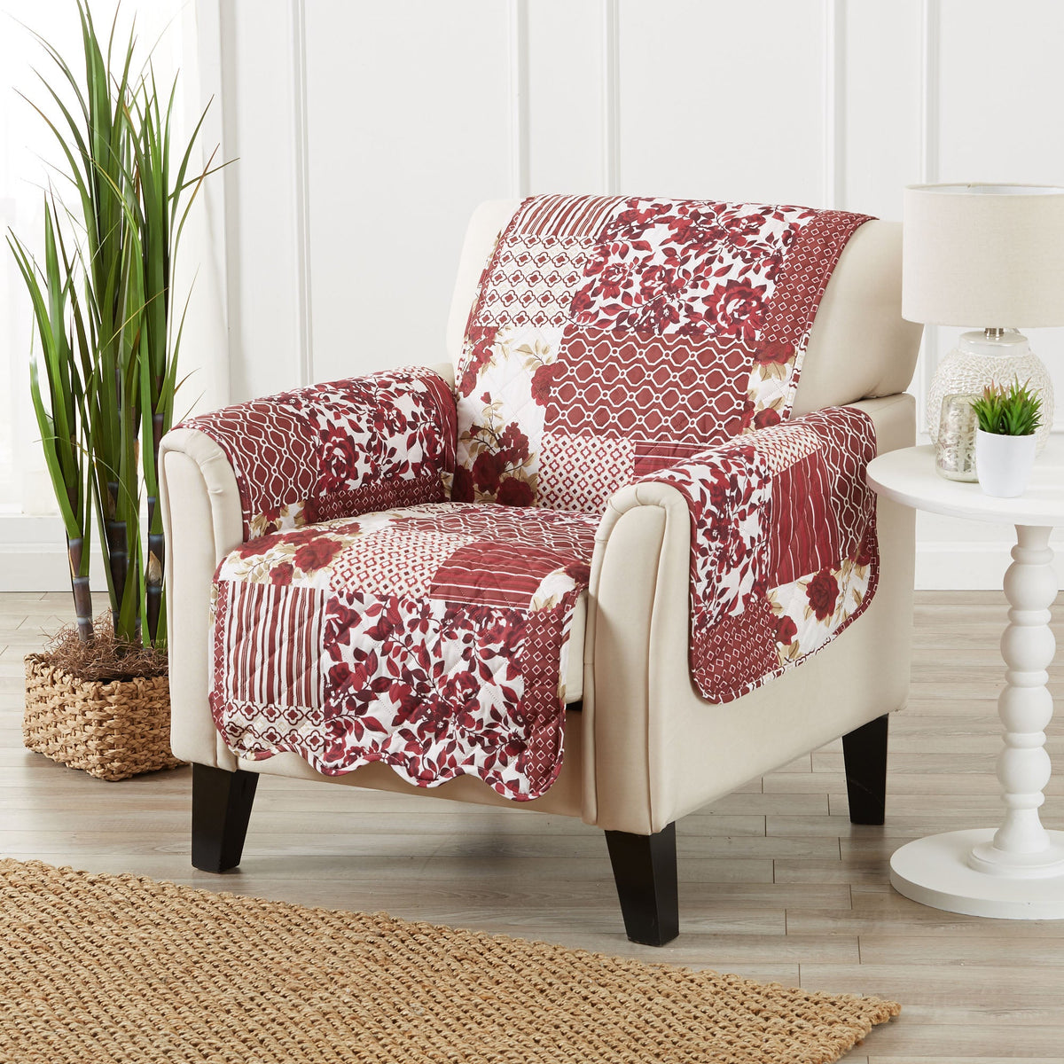 Reversible furniture protector with patchwork pattern in deep red and cream on armchair