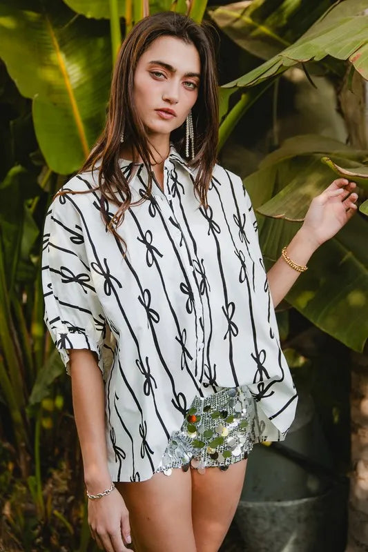 Off-white printed button-down shirt with short sleeves and black vertical pattern lines