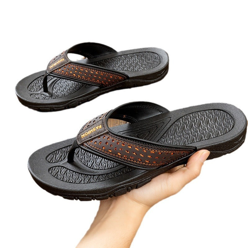 Black thong sandals with orange perforated strap, shown open toe and grippy tread