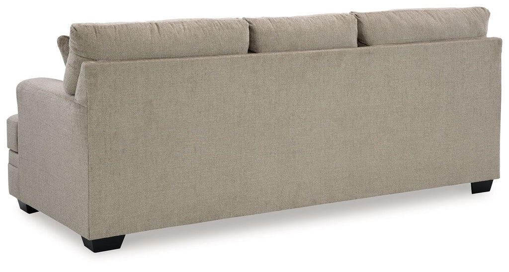 Light beige sofa back view with tight upholstery and black block feet