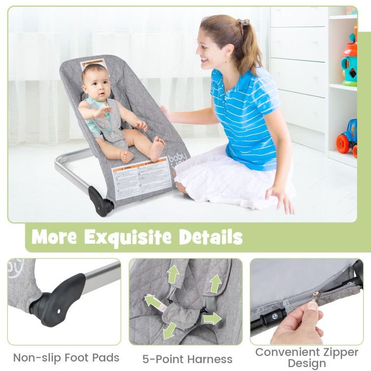 Gray baby bouncer seat with non-slip foot pads, 5-point harness, and zipper access