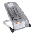Gray baby bouncer seat with padded insert and 5-point harness, reclined view
