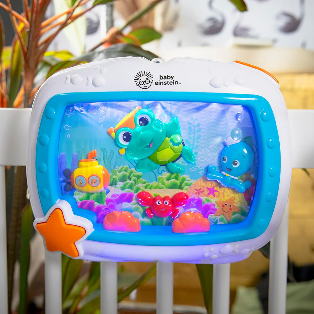 Front view of blue aquarium crib sound machine with orange star button and sea characters