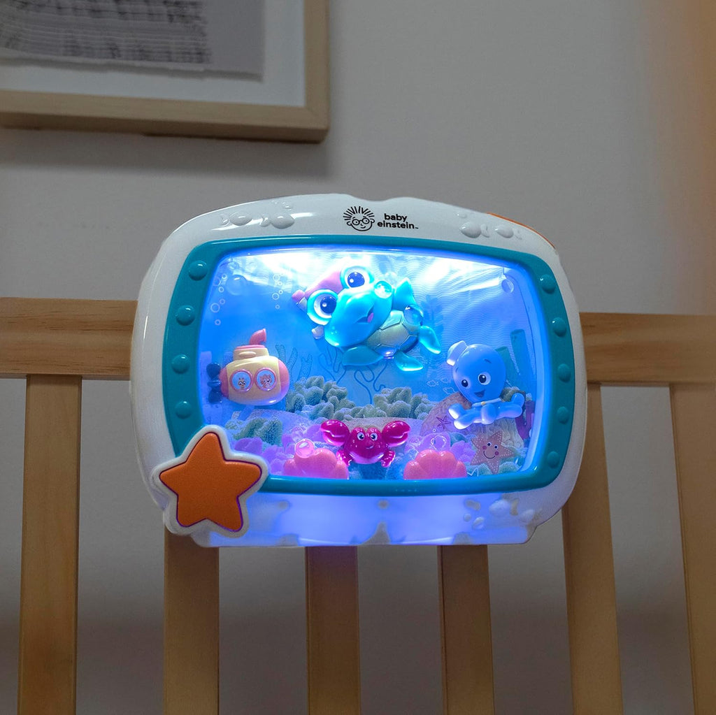 Sea-themed crib sound machine with glowing underwater characters and star-shaped side button
