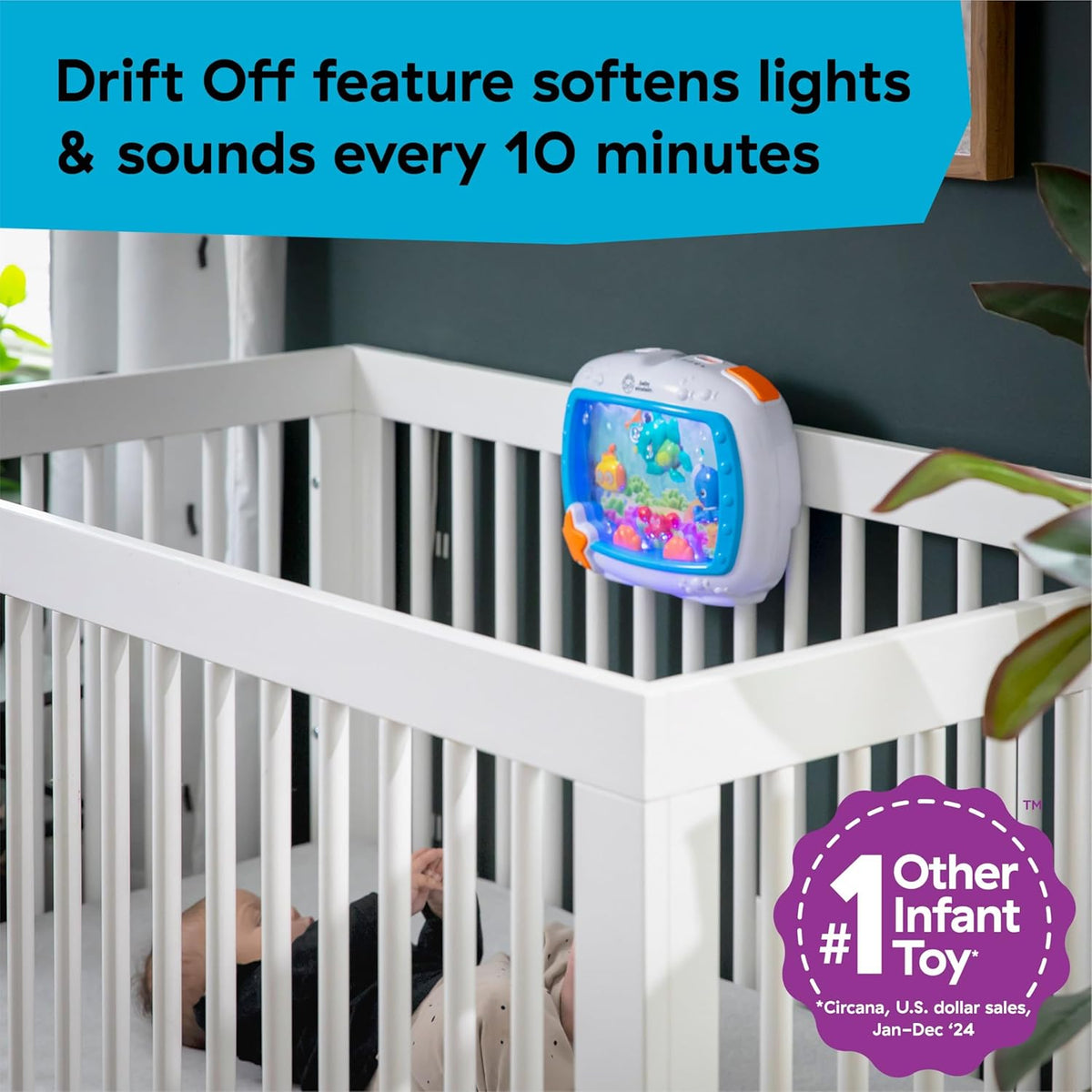 Baby Einstein sea-themed crib toy mounted behind white crib rails with lit blue screen