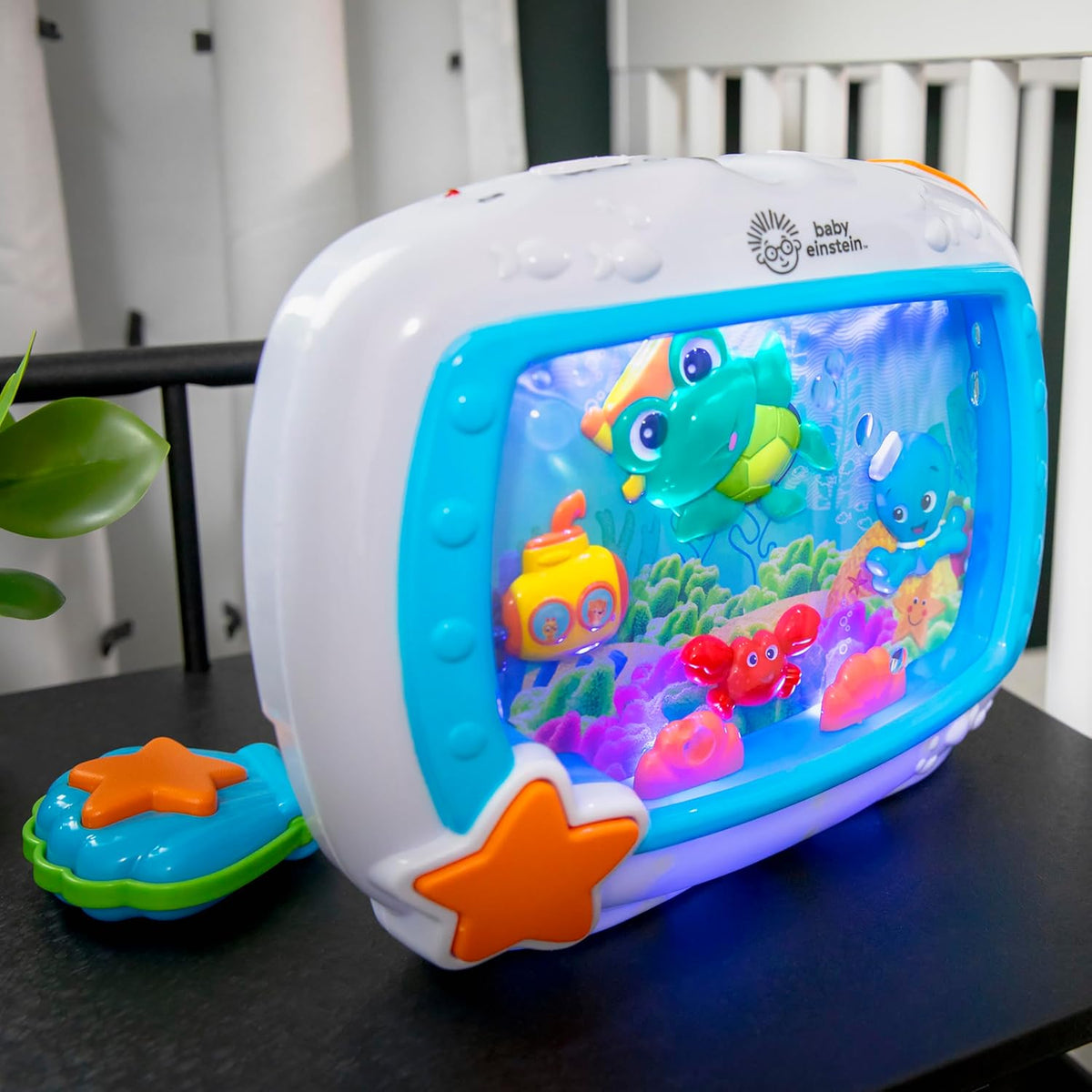Blue sea dreams sound machine on table with star button and ocean scene display