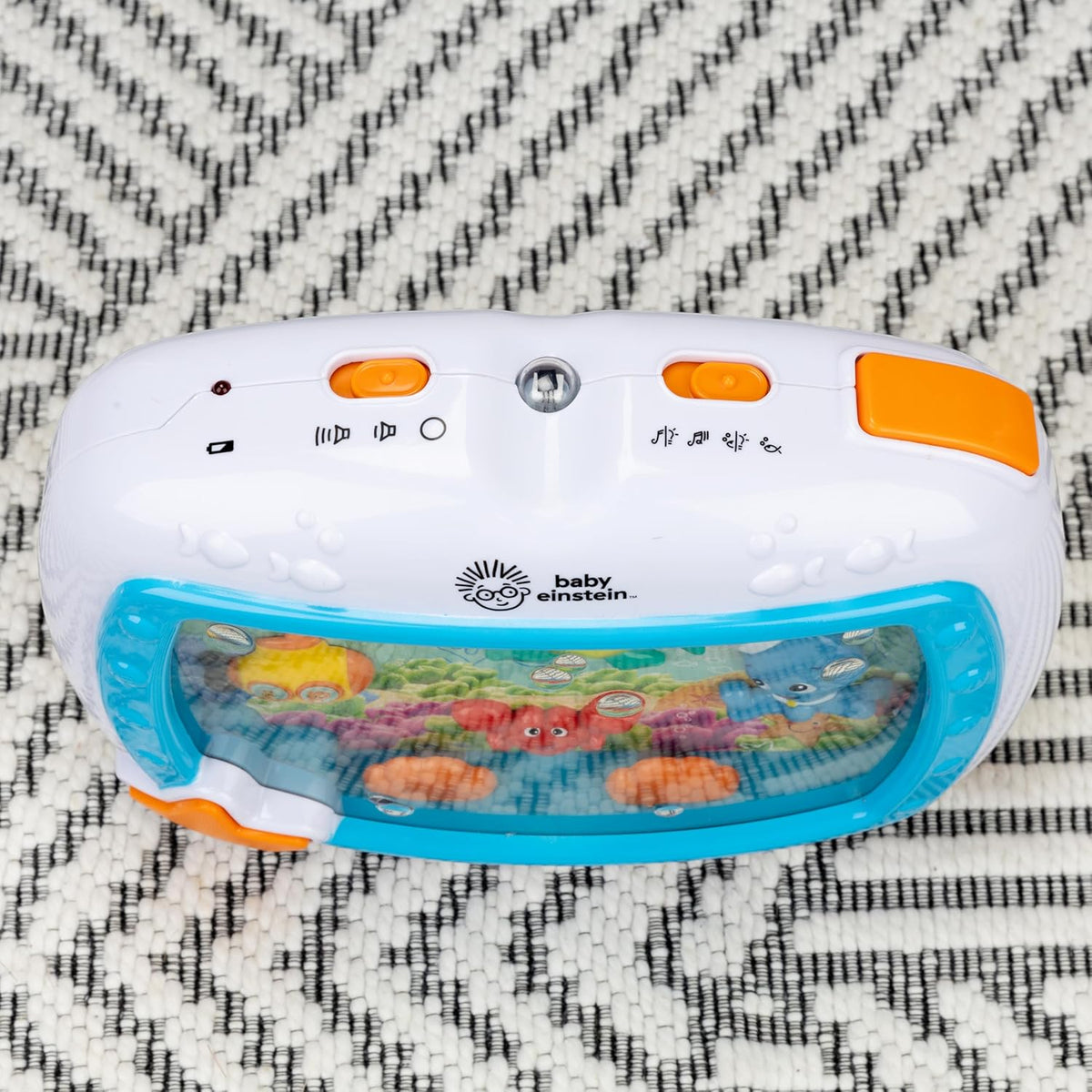 White crib soother sound machine with blue window and orange side controls