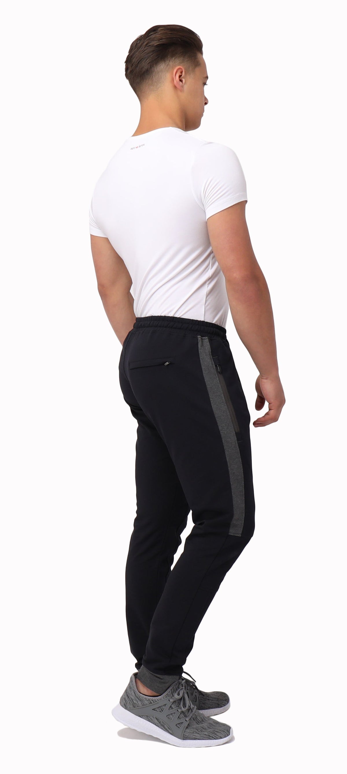 Tall fit jogger pants in dark color with side stripe, tapered leg, and ankle cuff