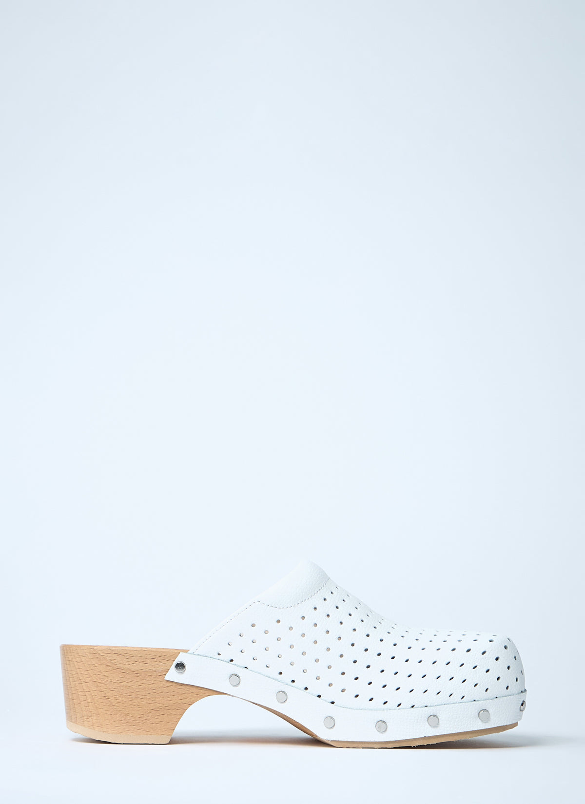 White perforated heeled clog with studded accents and light wood block heel