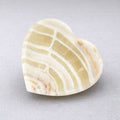 Cream and beige banded heart-shaped stone dish with natural veining