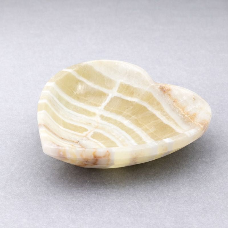 White and pale yellow banded heart-shaped stone dish with polished edge