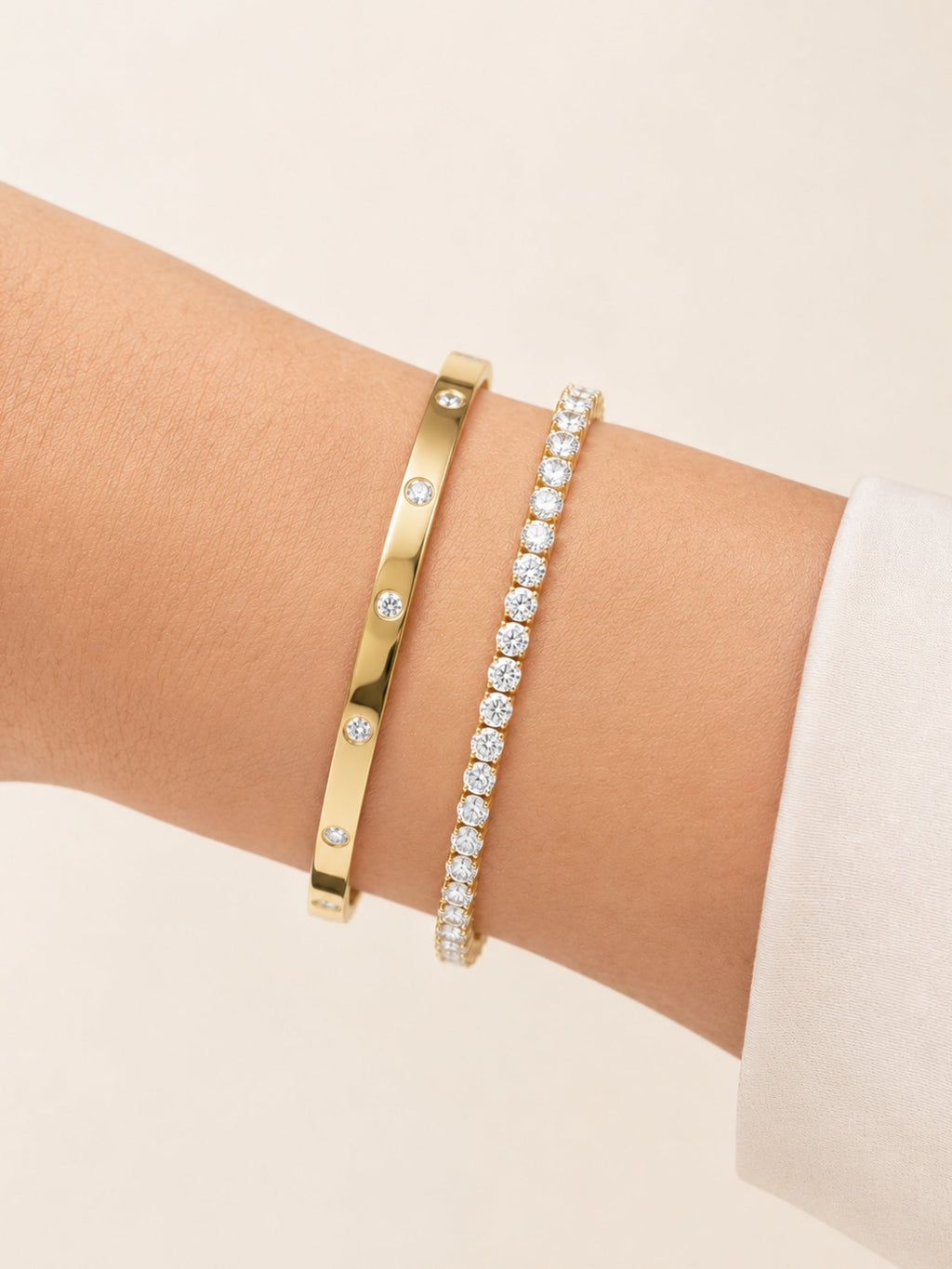 Gold bracelet bangle with inset round diamonds on slim band, side view close-up