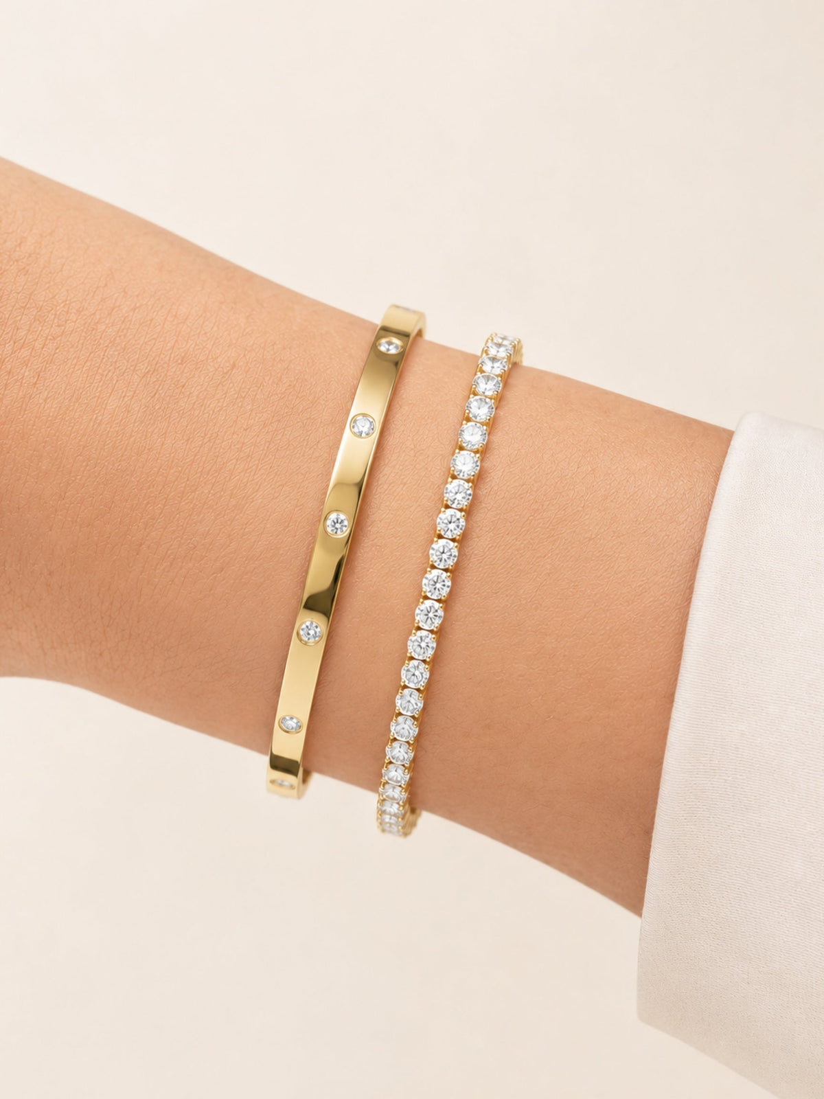 Gold bracelet bangle with inset round diamonds on slim band, side view close-up