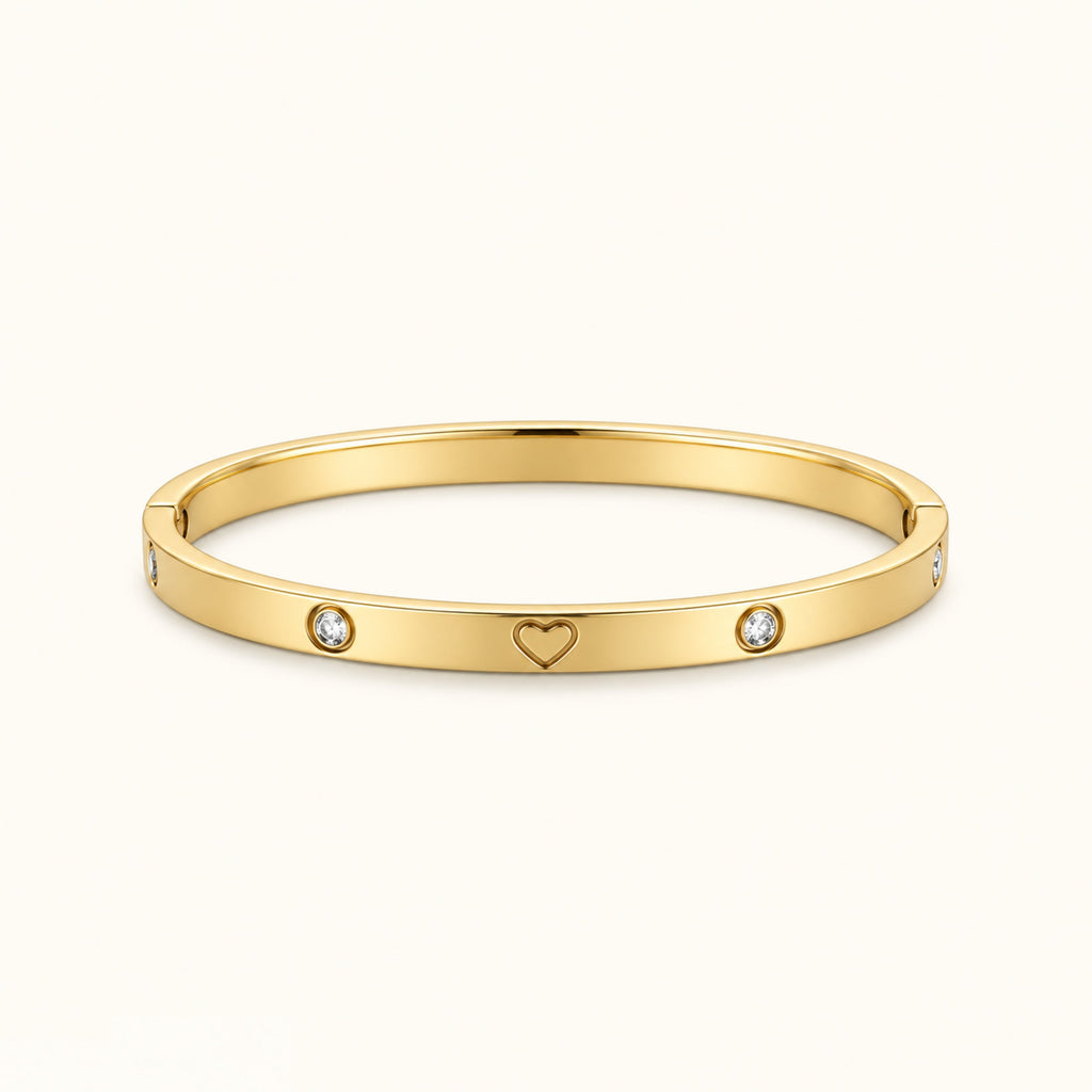Gold-tone heart bangle bracelet with two round diamond-like stones