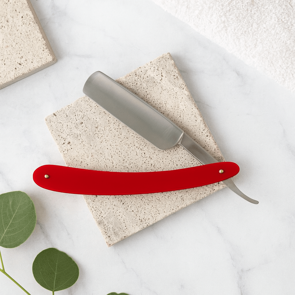 Red safety shaving razor with silver head and curved blade guard