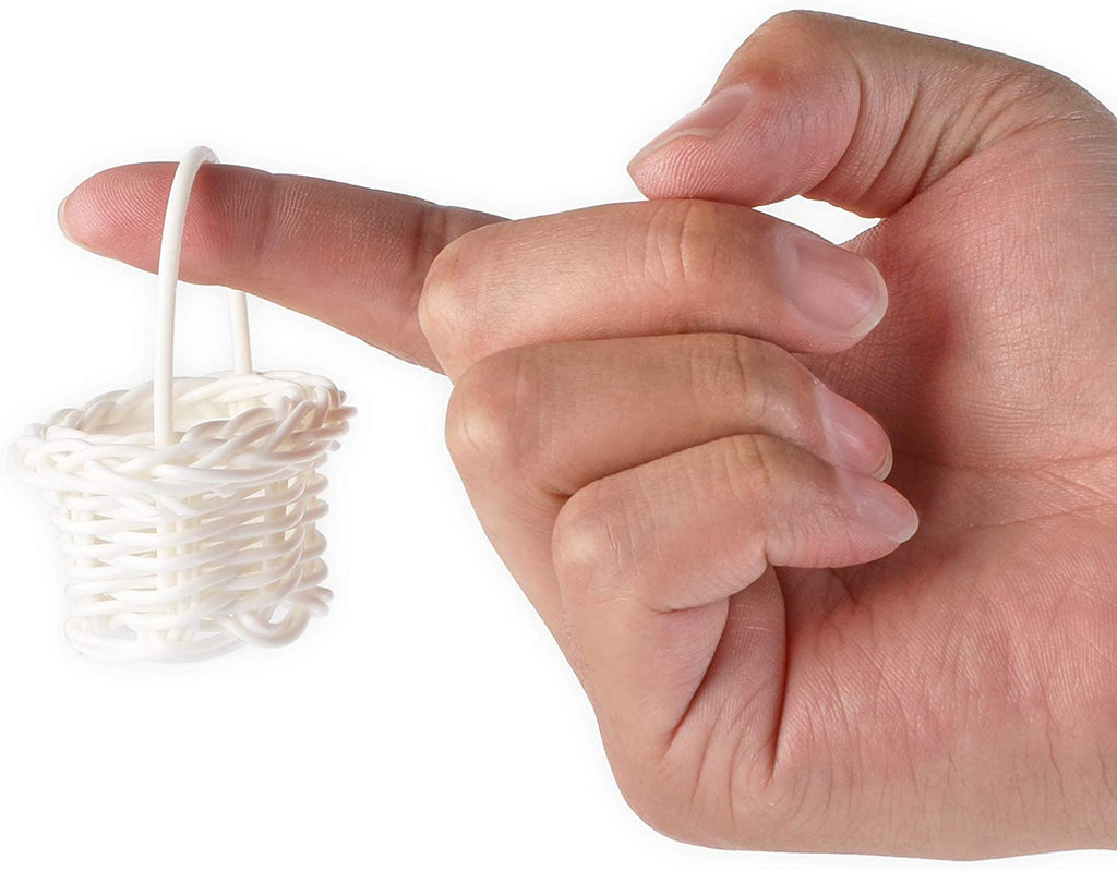 Hand holding a white wicker bath bomb basket
