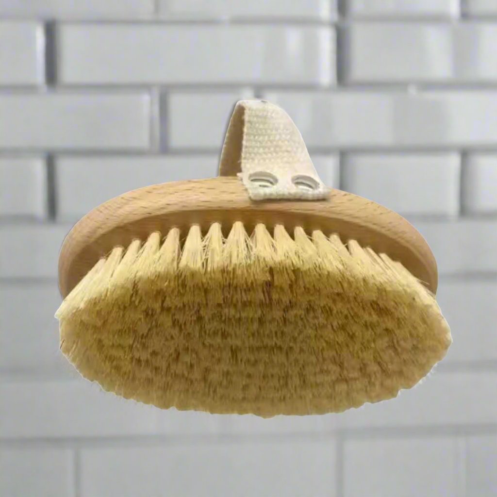 Oval bath brush with tan bristles and hanging loop on wooden back