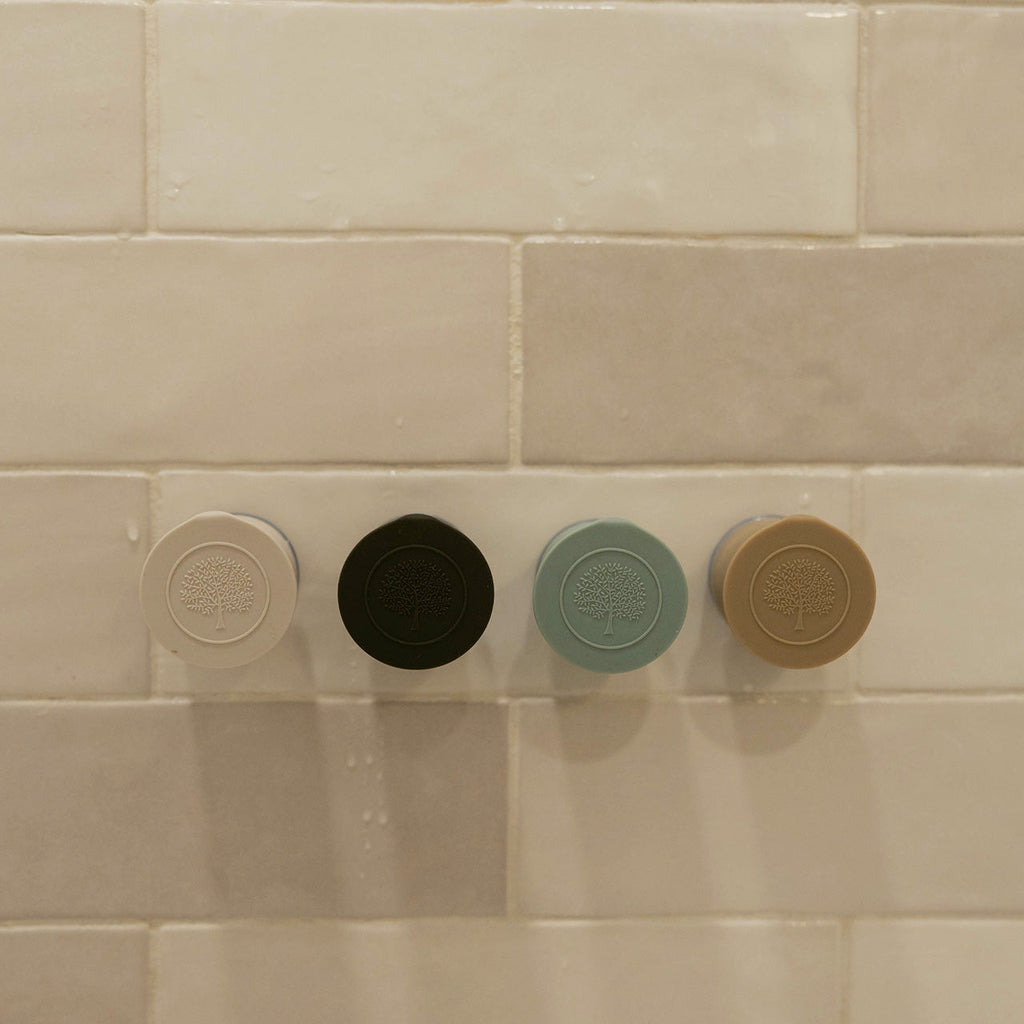Set of silicone bath hooks in multiple colors with embossed tree logos