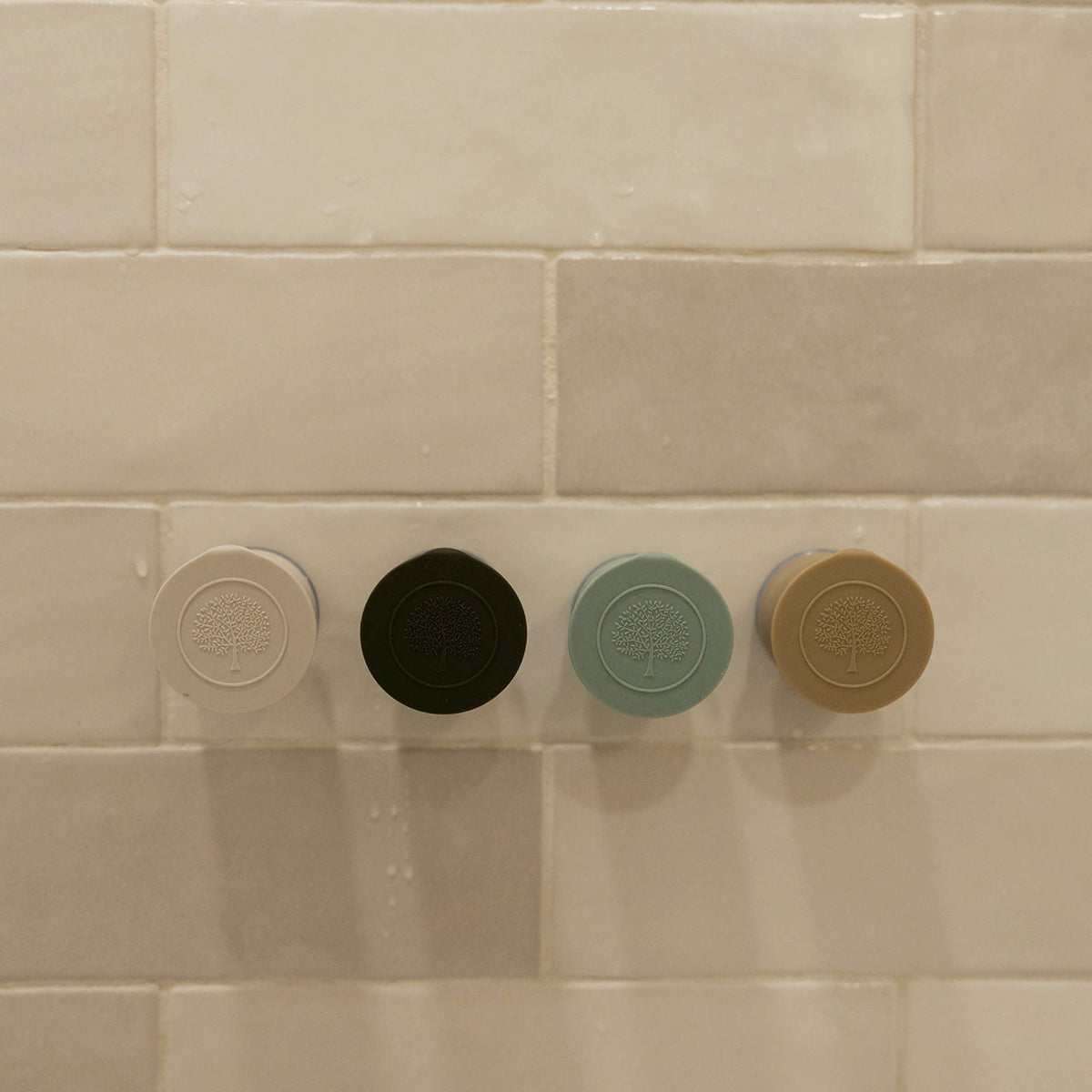 Set of silicone bath hooks in multiple colors with embossed tree logos