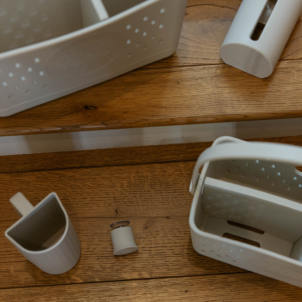 Silicone bath hook suction bases and clips on a wooden bathroom shelf