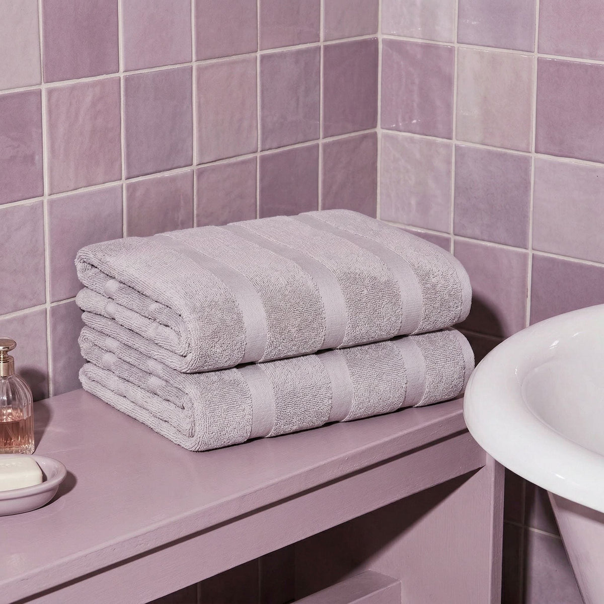 Lilac cotton bath towels, folded stack with striped bands