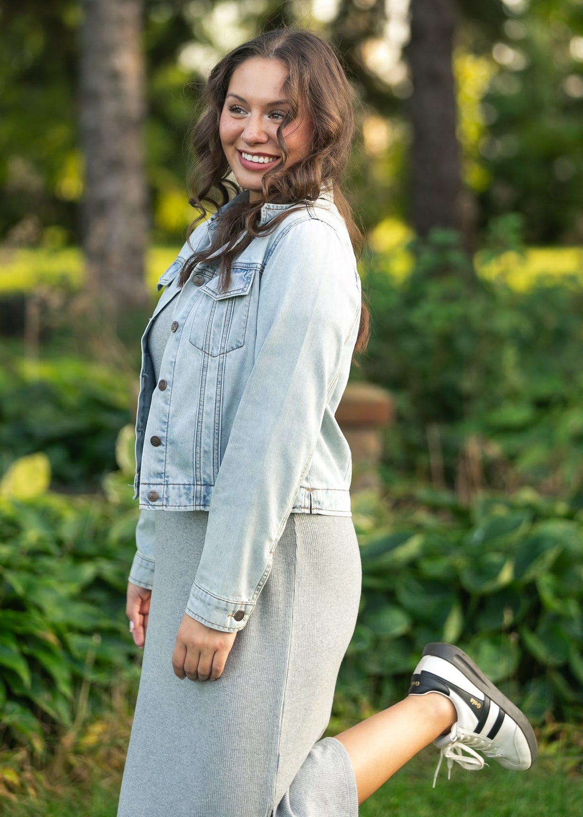 Gray ribbed t-shirt dress under light denim jacket, crew neck and short sleeves visible.