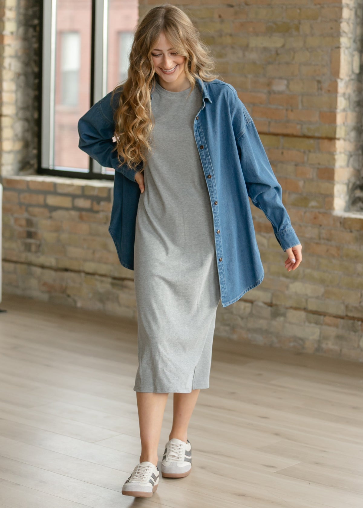 Gray ribbed midi t-shirt dress under a blue denim jacket, short sleeves visible