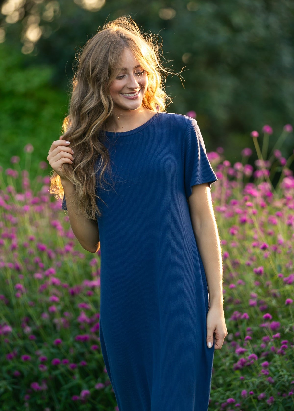 Navy t-shirt midi dress with short sleeves and crew neckline, draping fit.