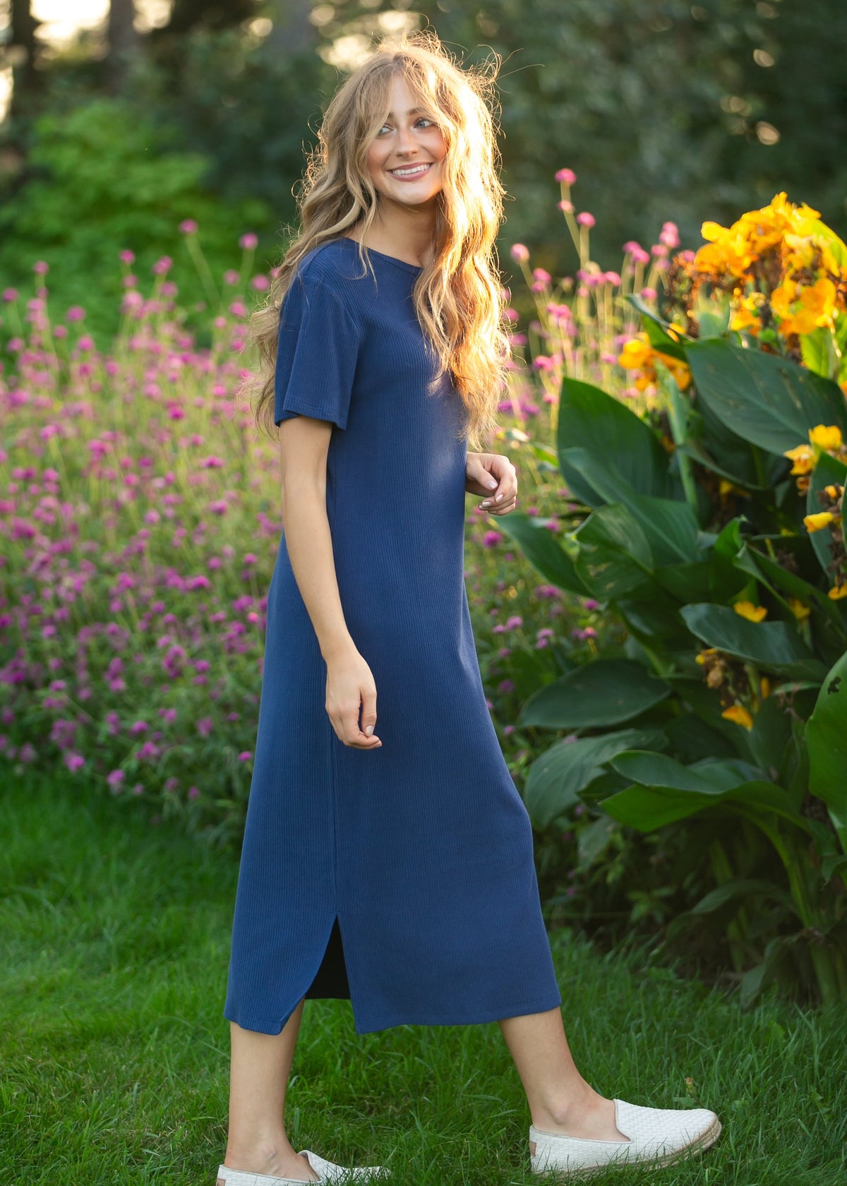 Navy t-shirt midi dress with short sleeves and crew neckline, visible front slit.
