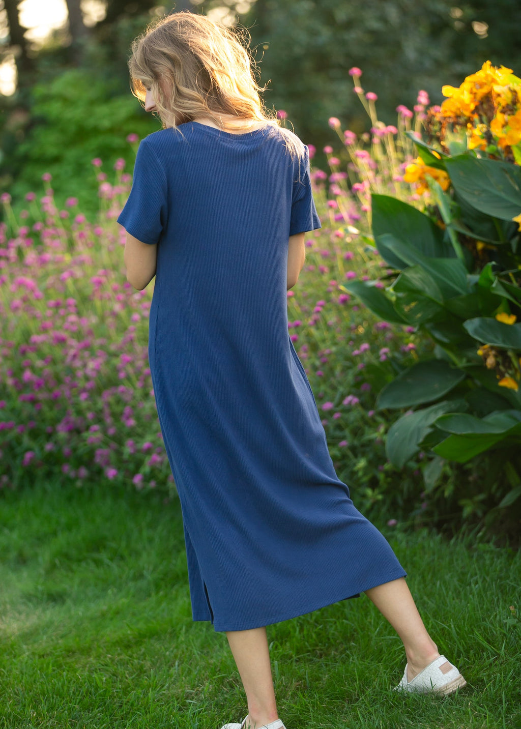 Back view of navy t-shirt midi dress with short sleeves and crew neckline.