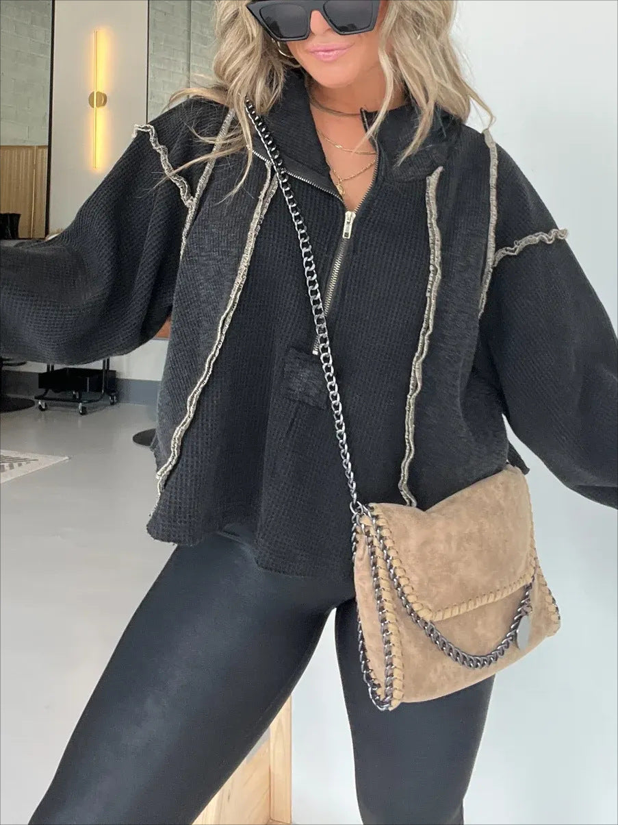 Black quarter-zip sweater with contrast rope trim and ribbed short cuffs